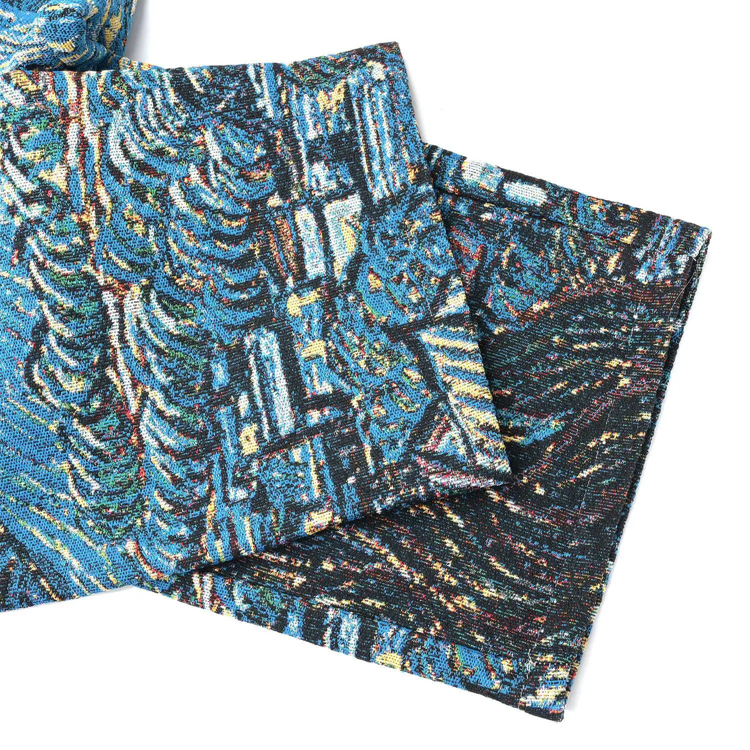 Folded lower legs of VERYRARE Starry Night pants showing dark cypress and village details in the tapestry.