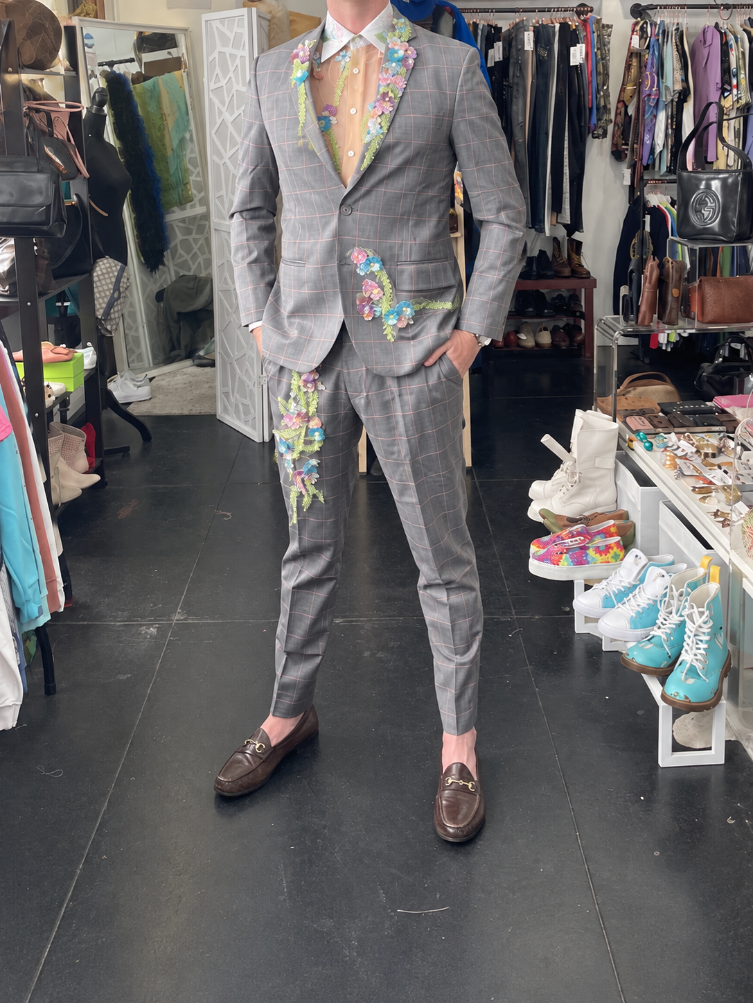 The complete coordinating wedding suit at a fitting.