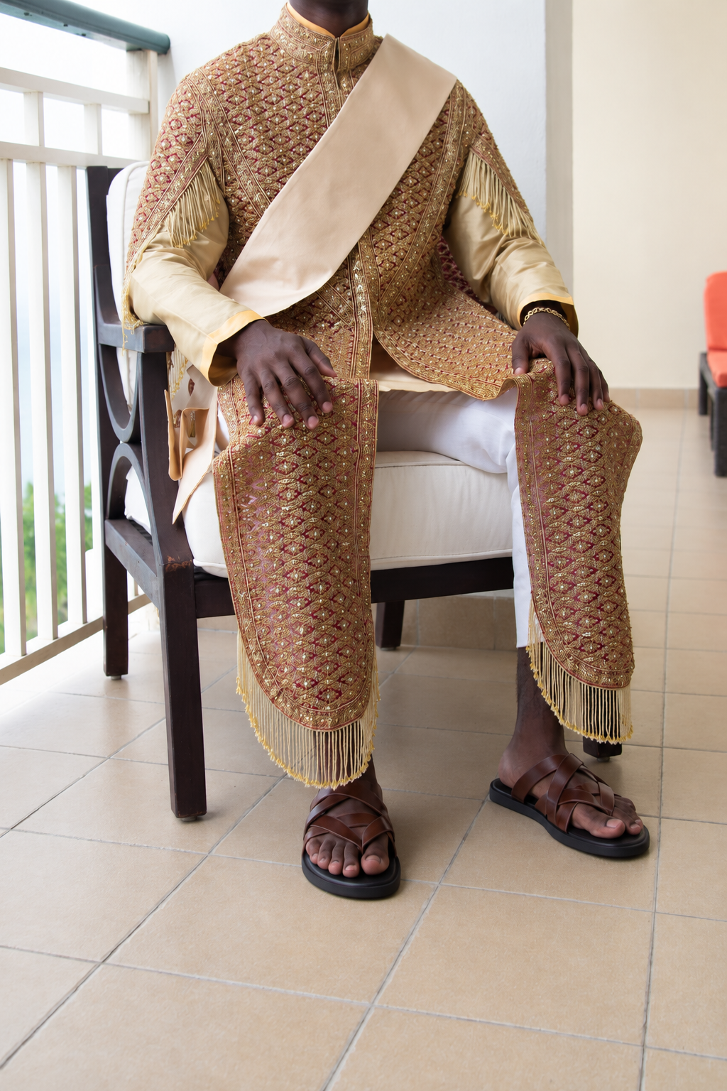 The complete seated look — collar, sash, panels, fringe and sandals.