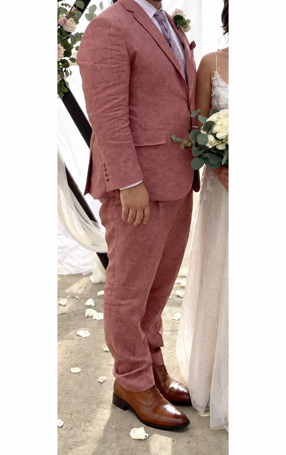 Rose-colored custom wedding suit, cropped below the client’s face