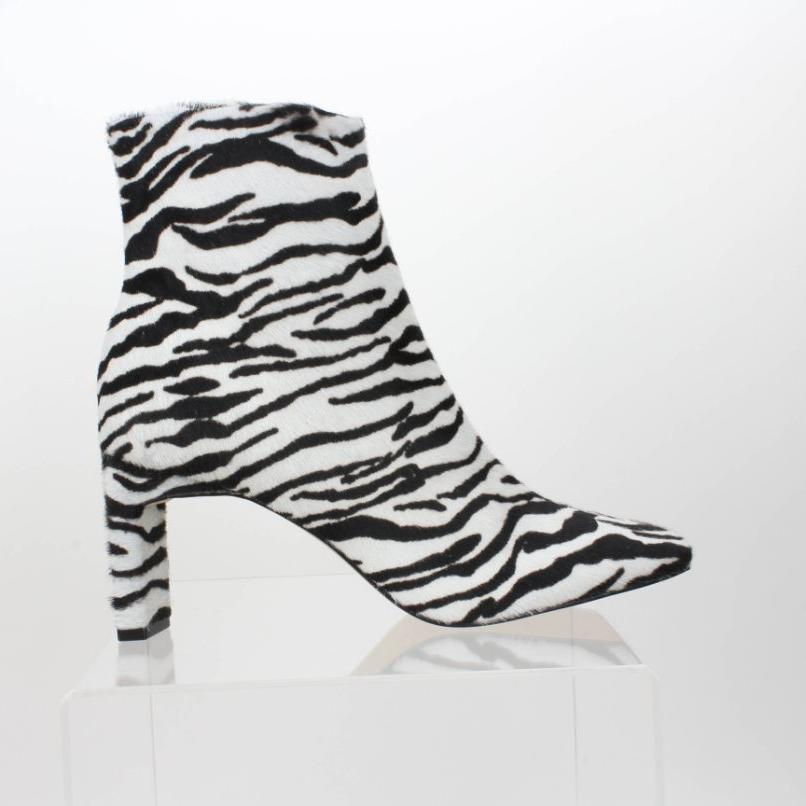 Complete side view of a Carrano black-and-white zebra-print calf-hair ankle boot, showing the square toe and covered sculptural heel.