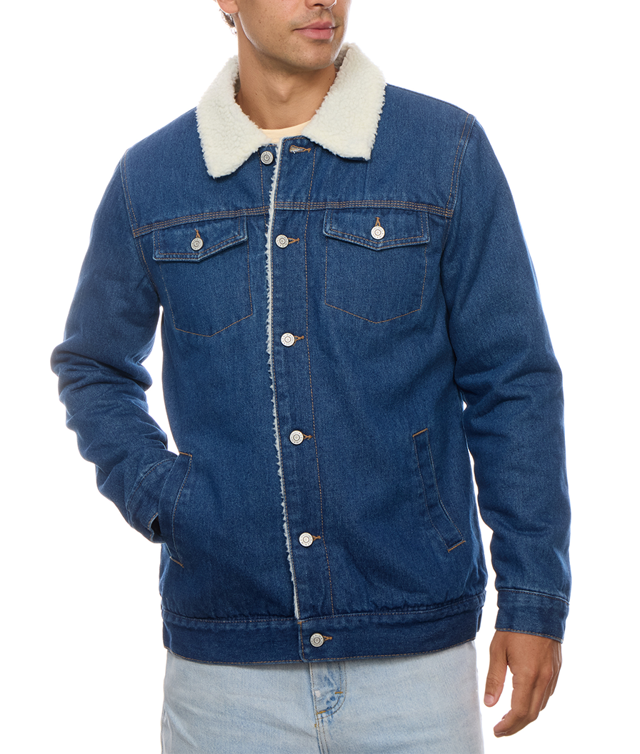 Nose-down model view of the PX denim trucker jacket buttoned at an angle, with the complete collar, pockets, sleeves and hem visible.