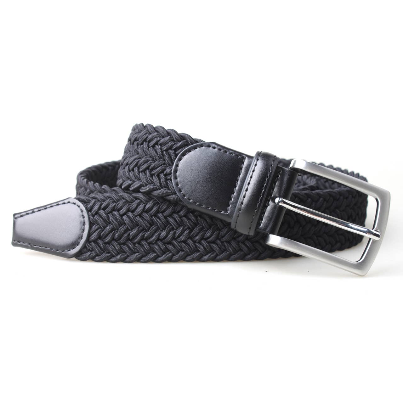 Black PX braided stretch belt coiled on white, showing the satin nickel-finish buckle and smooth leather tip.