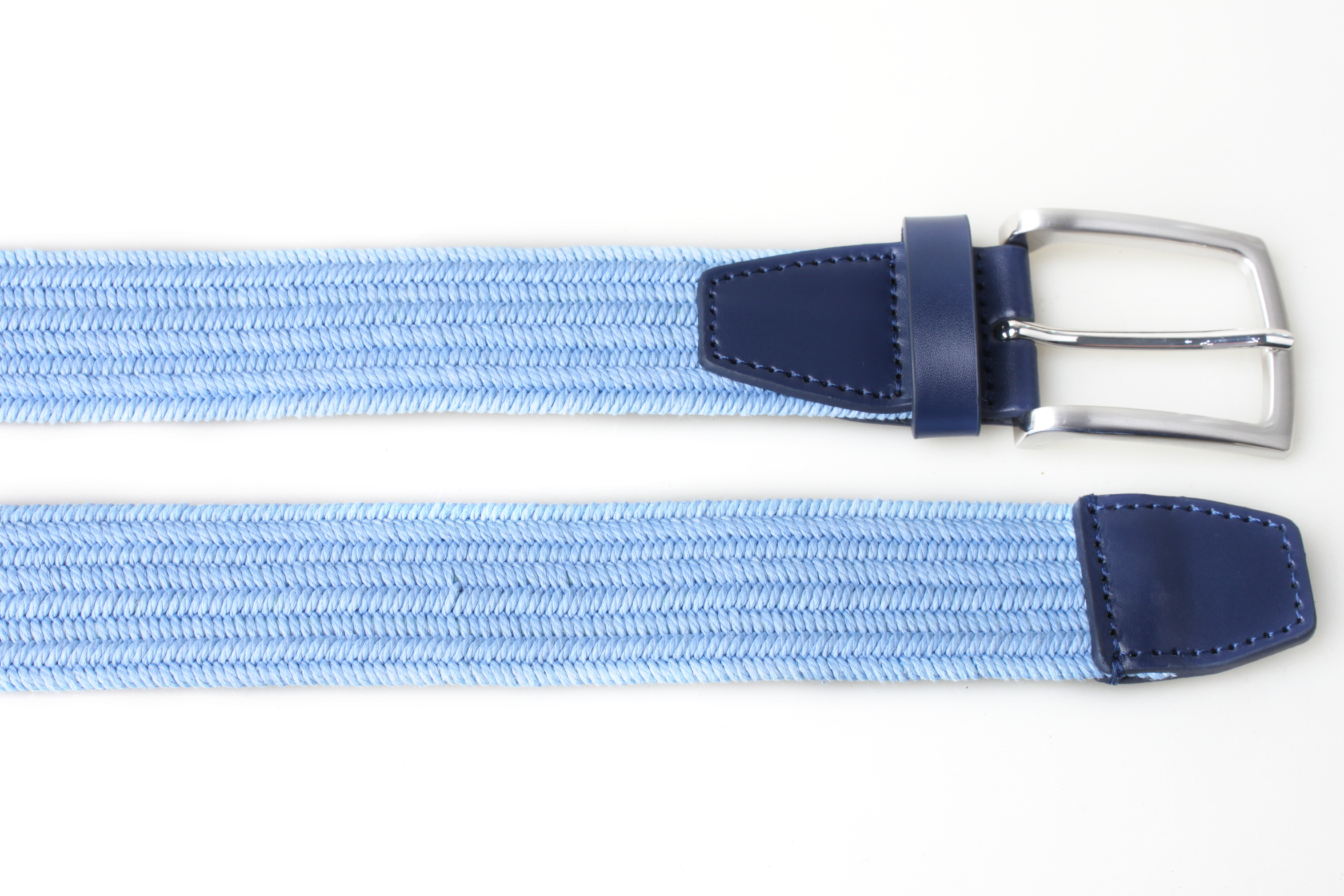 Light blue PX woven belt laid across a white background, showing the satin nickel-finish buckle and stitched navy leather trim.