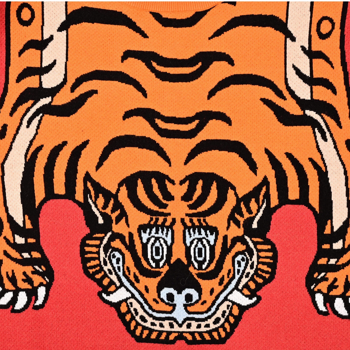 Close view of the orange, black and cream tiger face worked into the Tiger Rug jacquard knit