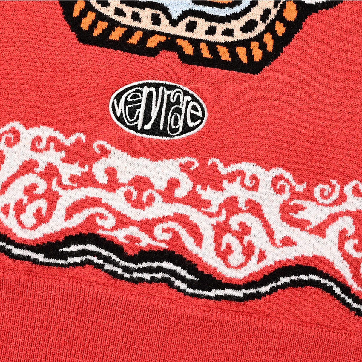 Close view of the VERYRARE oval embroidered logo and patterned border above the Tiger Rug ribbed hem
