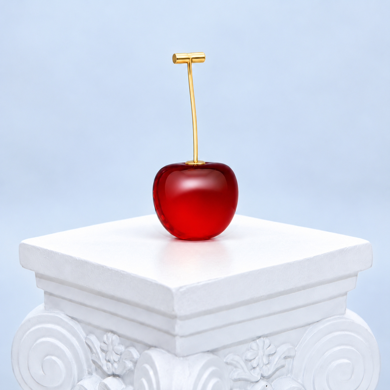 Front view of one Mio Queena red resin cherry earring with a fine gold-plated stem and horizontal T-bar