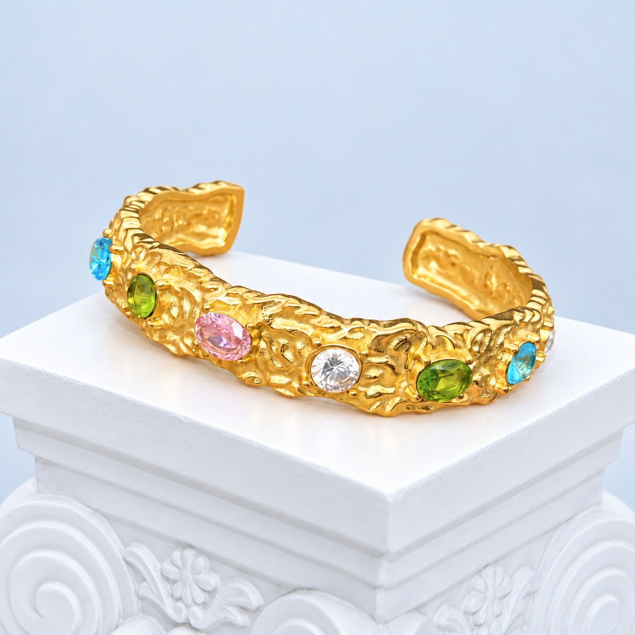 Complete front view of the Mio Queena hammered gold-plated cuff with colored zircon settings and open ends
