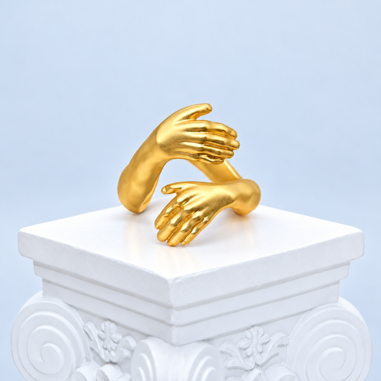 Oblique front view of the Mio Queena Embrace ring with defined sculpted fingers and thumbs