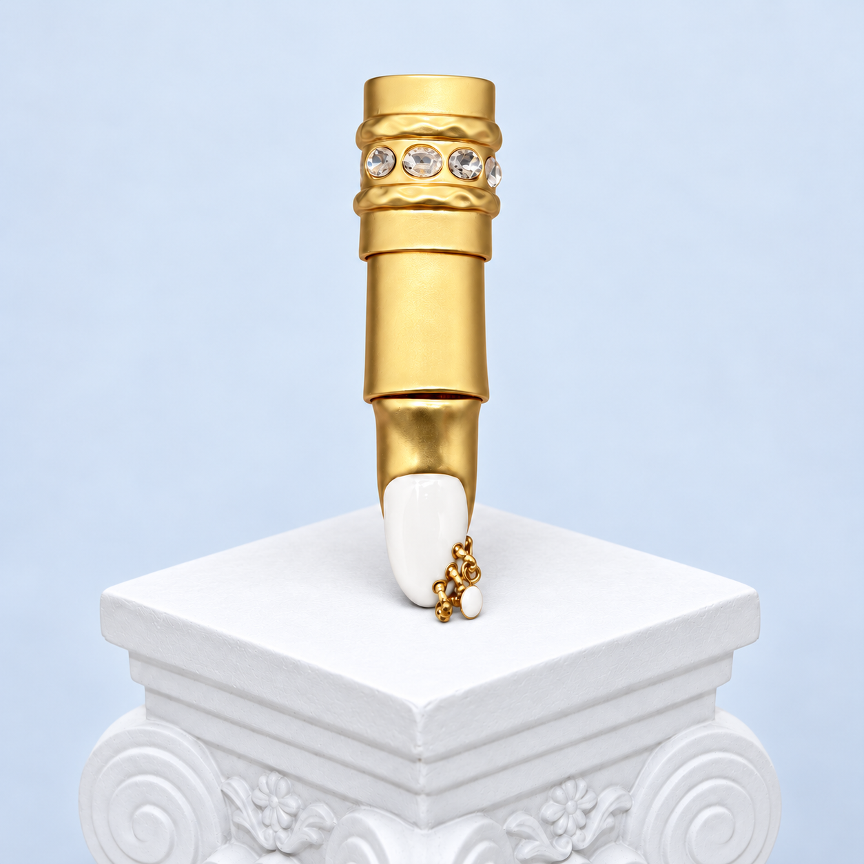 Straight full-length view of the Mio Queena White enamel finger ring, showing every gold-tone segment, clear accents, white nail and chain with one white drop.