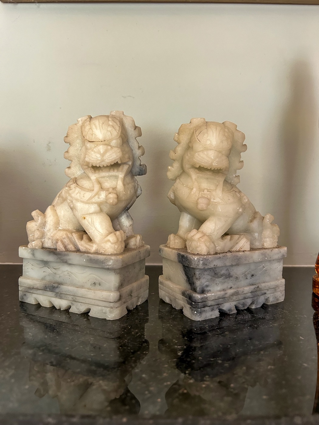 Pair of carved guardian lions on square stone bases from the Tom Culver collection